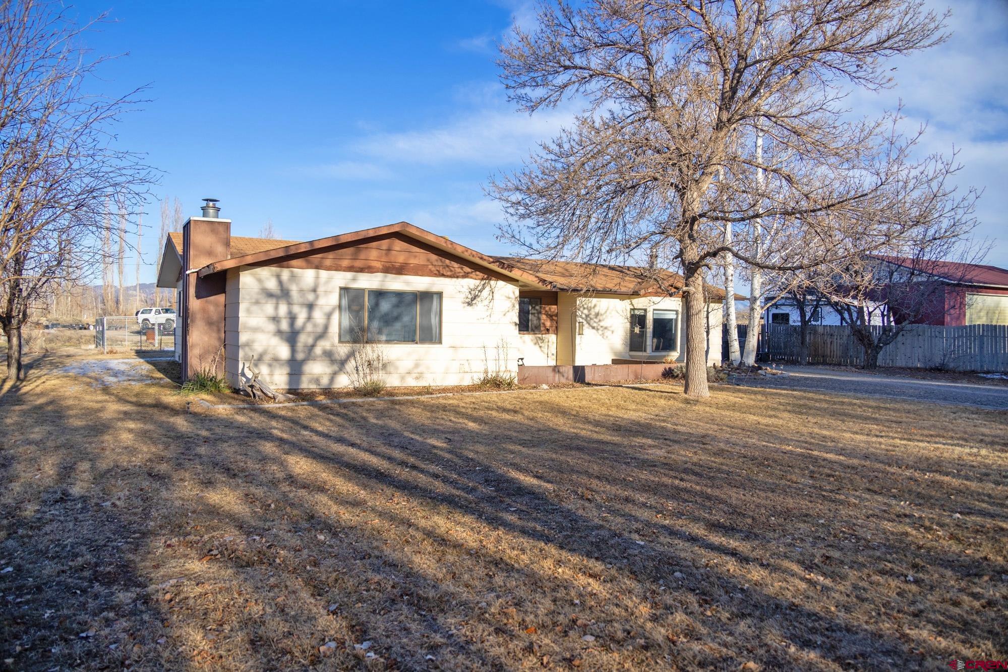 11500 6250th Road Montrose, CO 81401 - Photo 3 of 35 a front view of a house with a yard