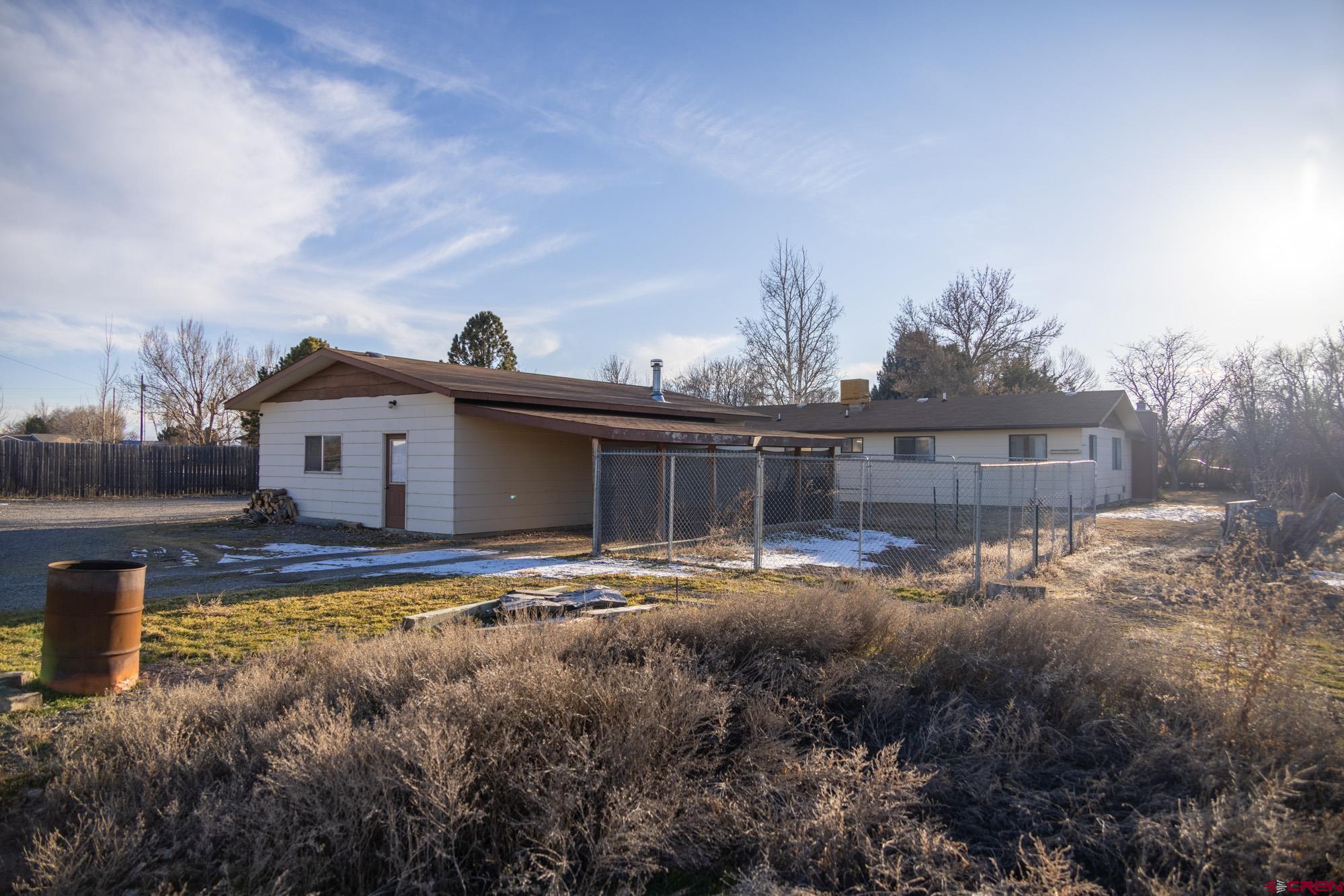 11500 6250th Road Montrose, CO 81401 - Photo 31 of 35 a view of house with backyard and trees in the background