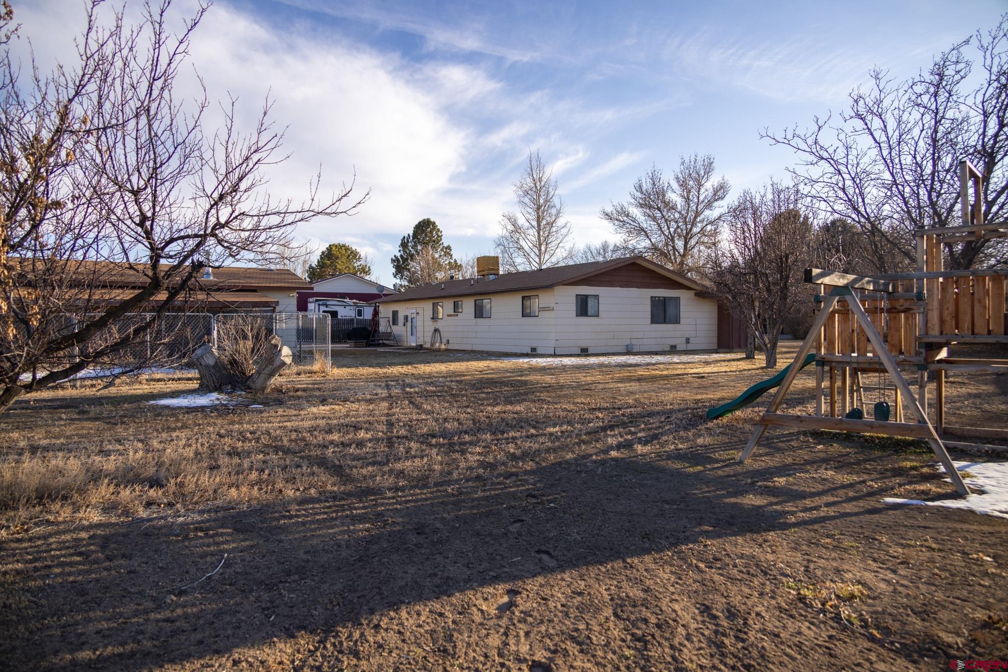 11500 6250th Road Montrose, CO 81401 - Photo 33 of 35 a view of a house with a yard covered with snow