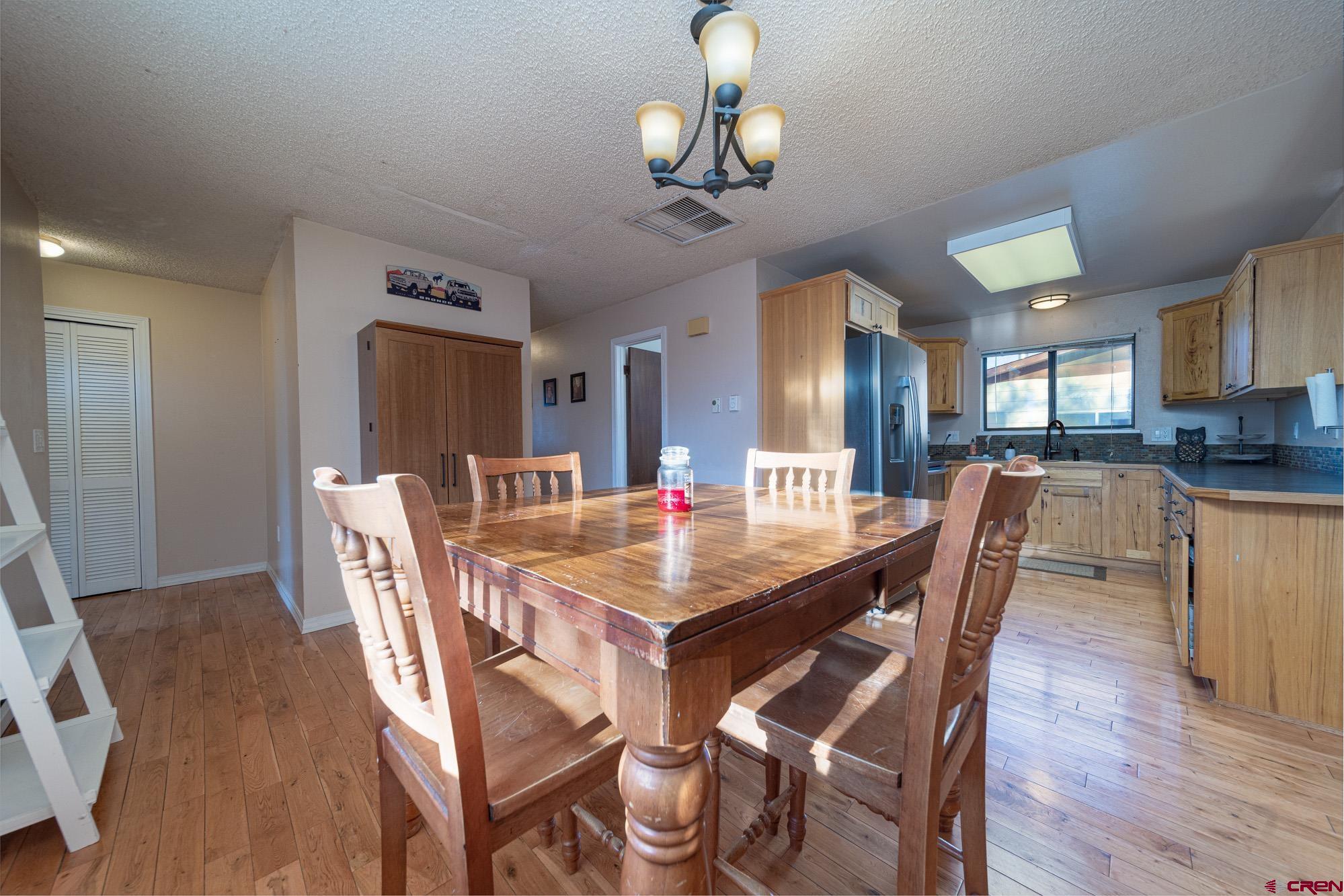11500 6250th Road Montrose, CO 81401 - Photo 4 of 35 a view of a dining room with furniture and wooden floor