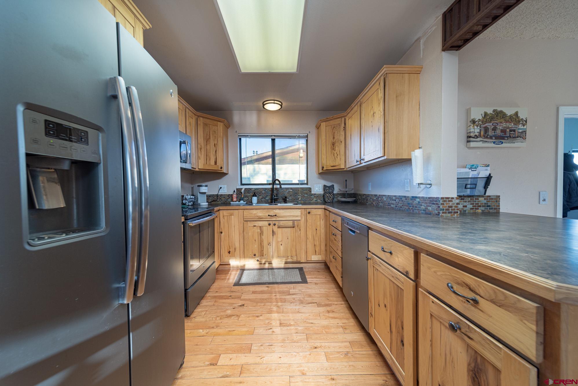11500 6250th Road Montrose, CO 81401 - Photo 5 of 35 a kitchen with granite countertop stainless steel appliances a sink and counter space