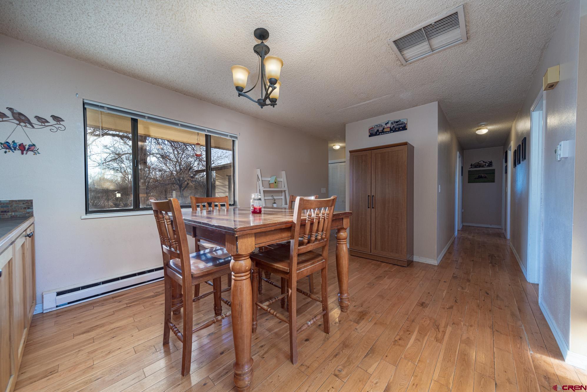 11500 6250th Road Montrose, CO 81401 - Photo 7 of 35 a view of a dining room with furniture window and wooden floor