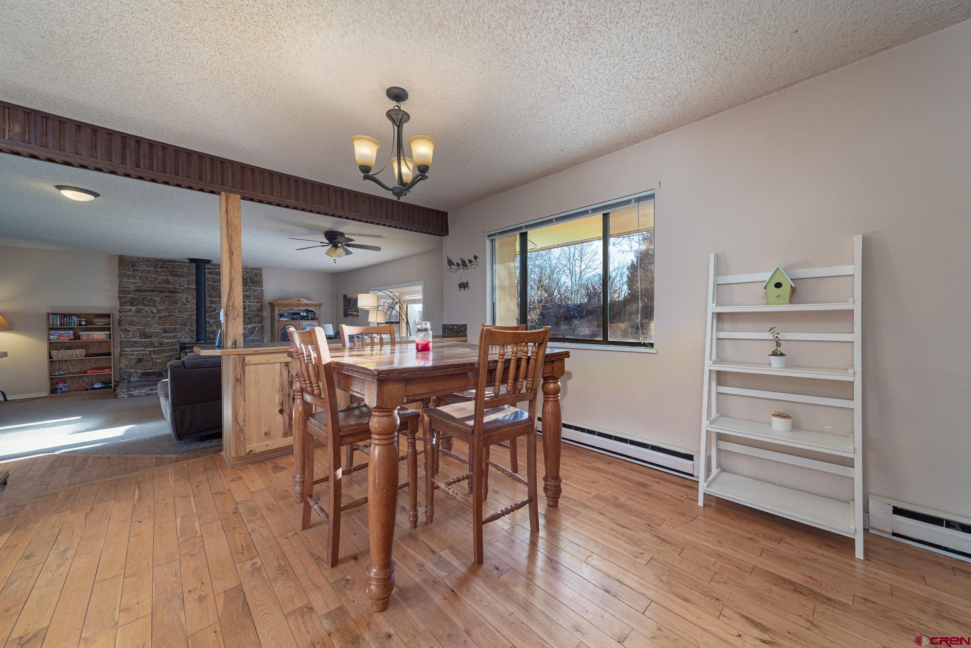 11500 6250th Road Montrose, CO 81401 - Photo 8 of 35 a view of a dining room with furniture window and wooden floor