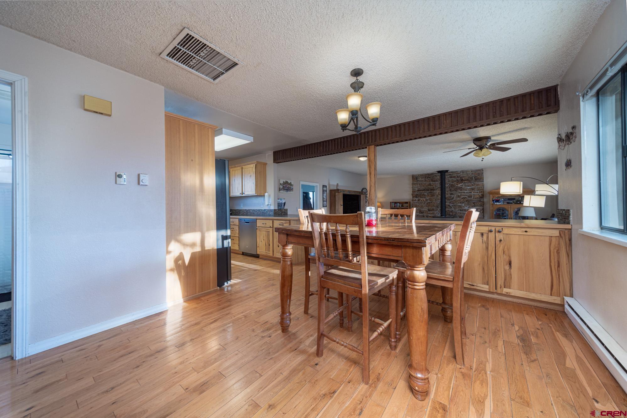 11500 6250th Road Montrose, CO 81401 - Photo 9 of 35 a view of a dining room with furniture and wooden floor