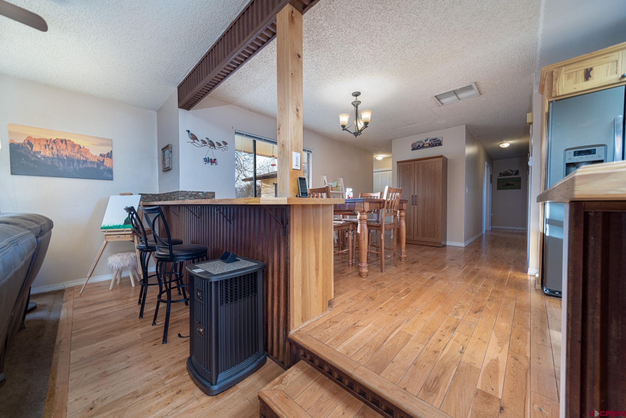 11500 6250th Road Montrose, CO 81401 - Photo 10 of 35 a dining room with furniture and wooden floor