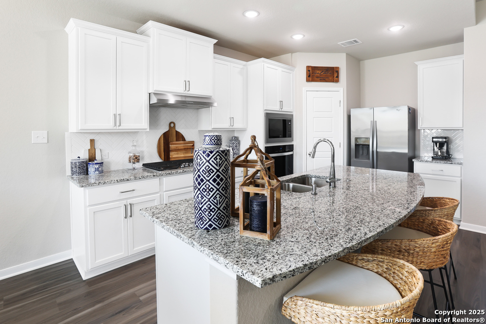 315 Canton Chase Cibolo, TX 78108 - Photo 18 of 36 a kitchen with stainless steel appliances granite countertop a sink a stove and a refrigerator