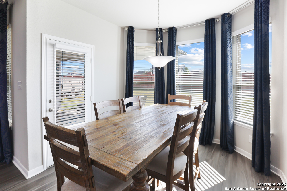 315 Canton Chase Cibolo, TX 78108 - Photo 21 of 36 a view of a dining room with furniture window and wooden floor