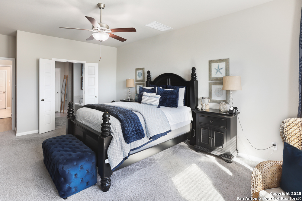 315 Canton Chase Cibolo, TX 78108 - Photo 25 of 36 a bedroom with a bed and a chandelier