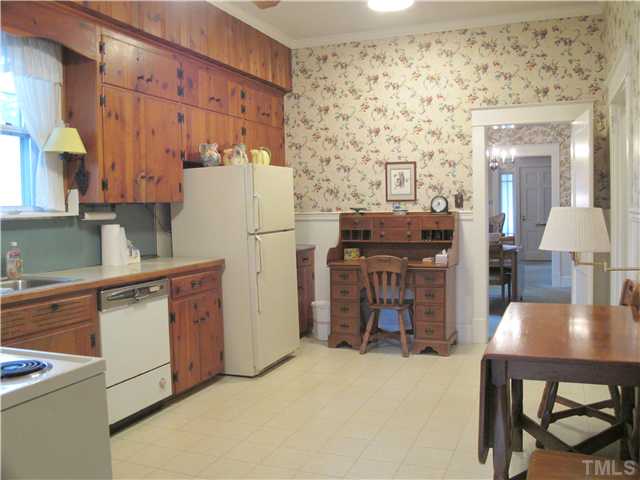 1814 Arlington Street Raleigh, NC 27608 - Photo 11 of 20 a kitchen with a refrigerator and a table