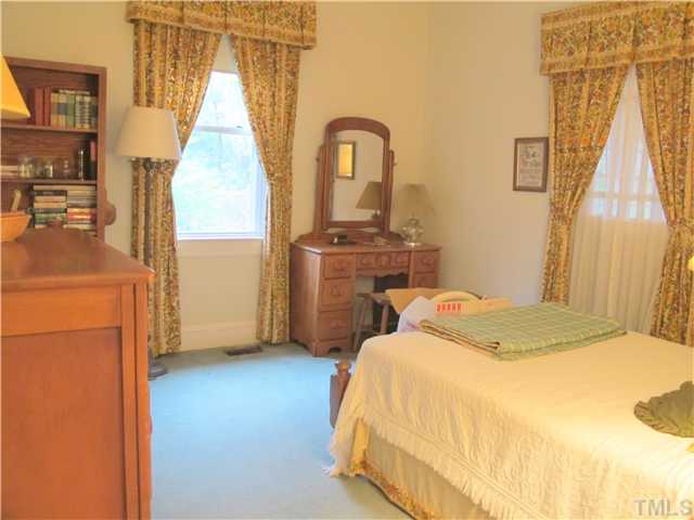 1814 Arlington Street Raleigh, NC 27608 - Photo 14 of 20 a bedroom with a bed and a flat tv screen on dresser
