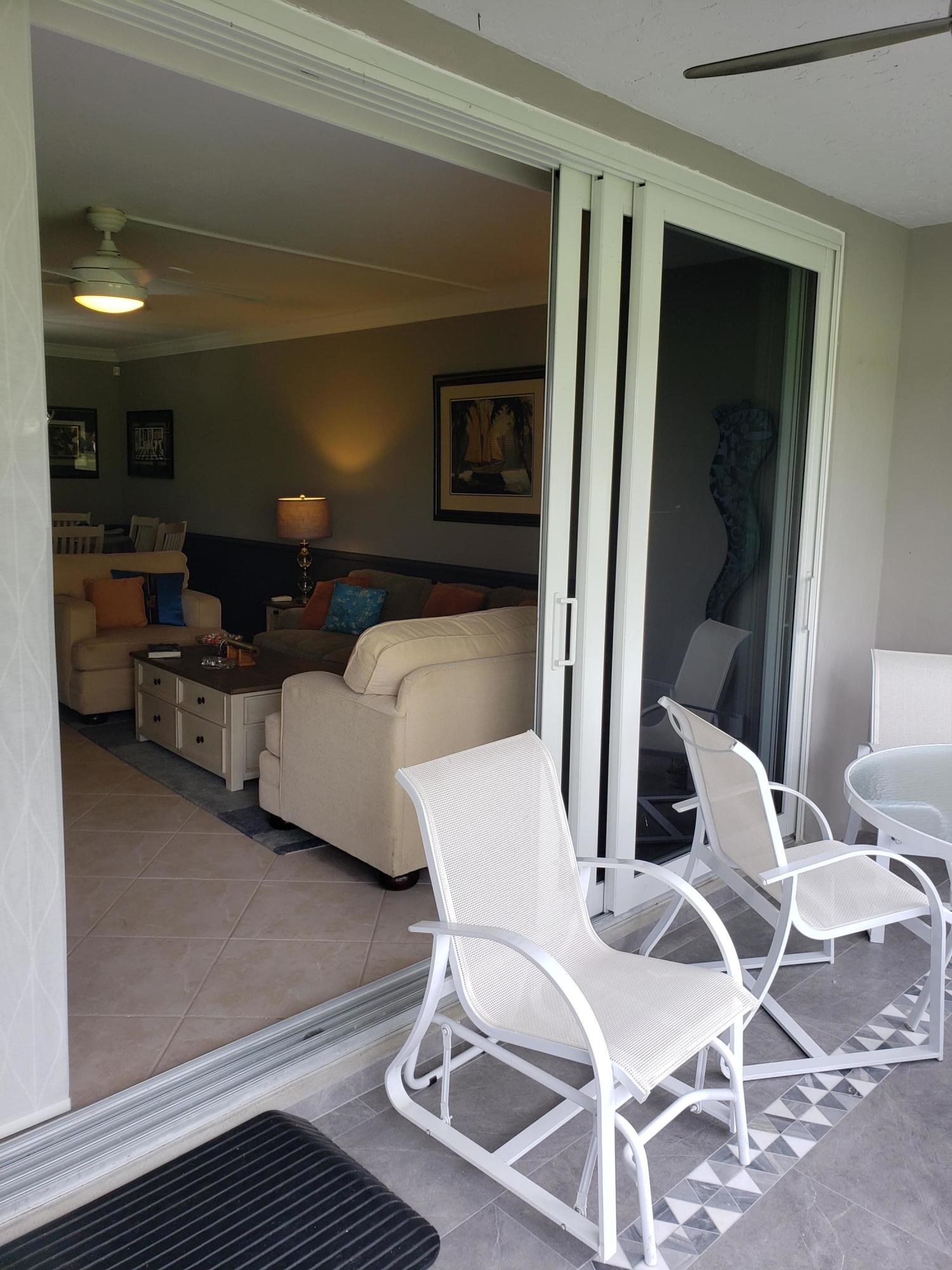 3980 Oaks Clubhouse Drive, Unit 101 Pompano Beach, FL 33069 - Photo 12 of 31 Living Room Patio