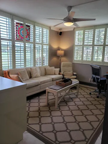 a living room with a bookshelf and a flat screen tv