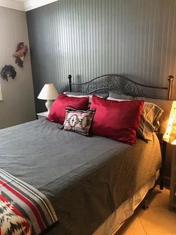 a bed sitting in a bedroom next to a window