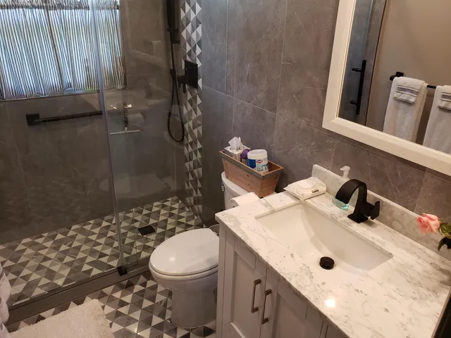 a bathroom with a sink vanity and a mirror