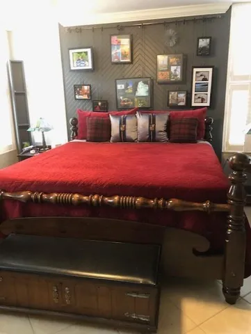 a bathroom with a granite countertop toilet sink and mirror
