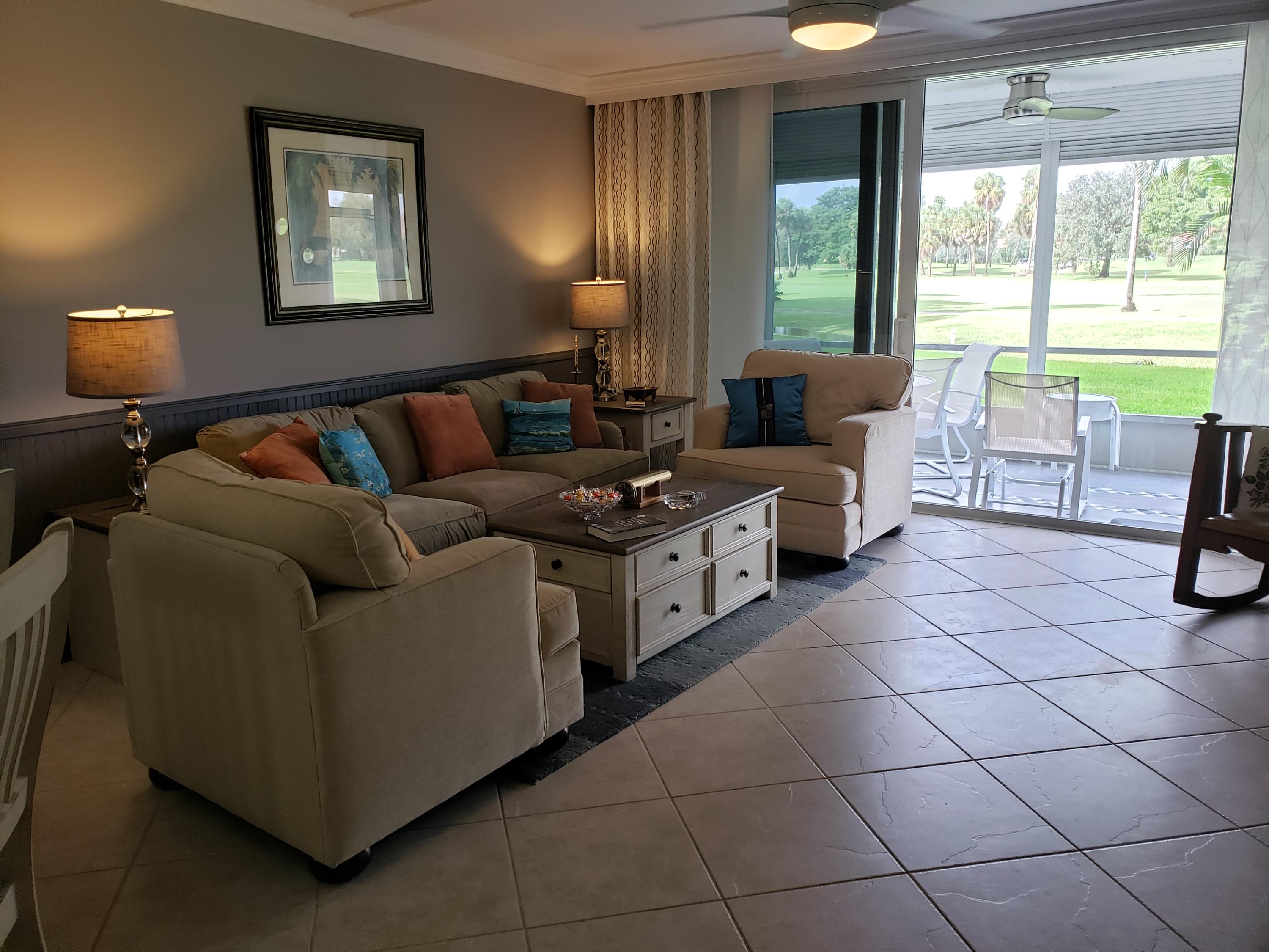 3980 Oaks Clubhouse Drive, Unit 101 Pompano Beach, FL 33069 - Photo 8 of 31 Living Room Facing Gold Course