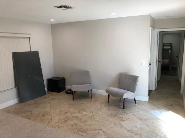 a living room with furniture and a chair