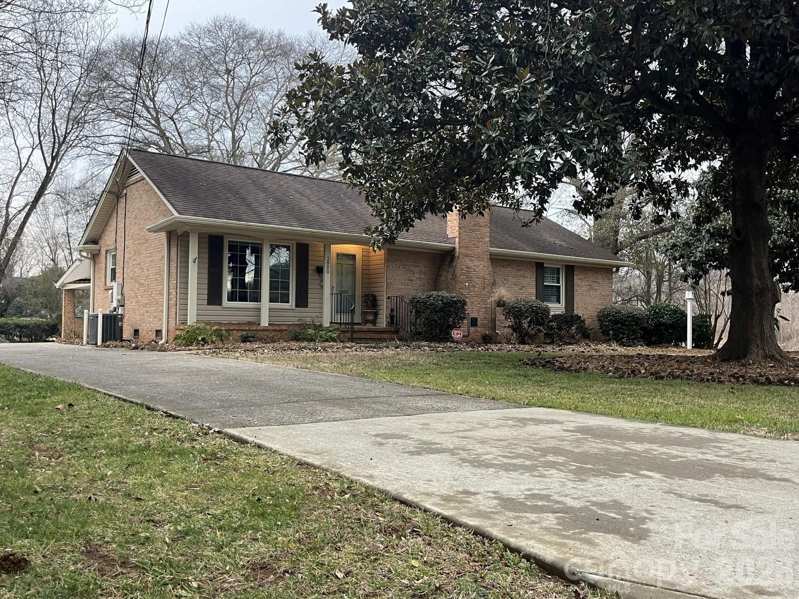 2800 Spring Valley Road Charlotte, NC 28210 - Photo 1 of 31 a front view of a house with a yard