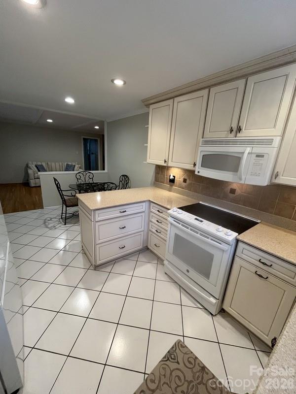 2800 Spring Valley Road Charlotte, NC 28210 - Photo 14 of 31 a kitchen with a sink a stove cabinets and counter space
