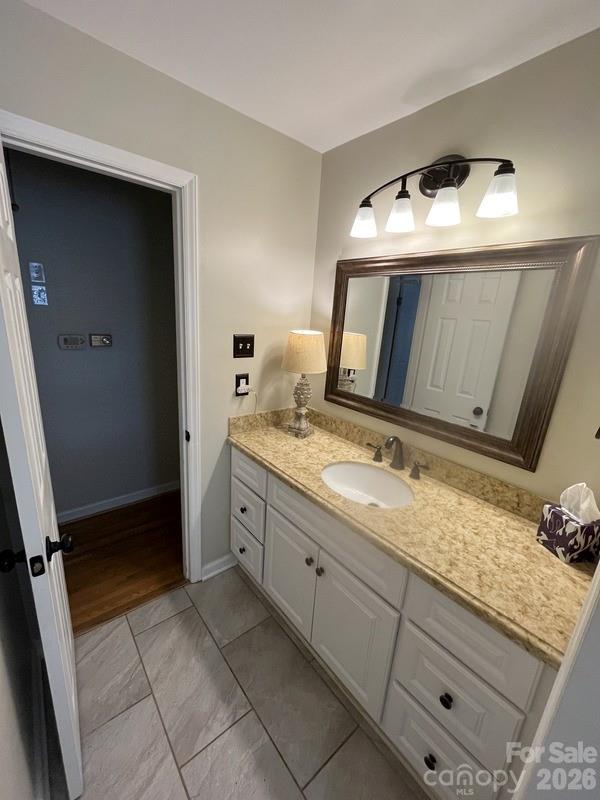 2800 Spring Valley Road Charlotte, NC 28210 - Photo 19 of 31 a bathroom with a granite countertop sink and a mirror