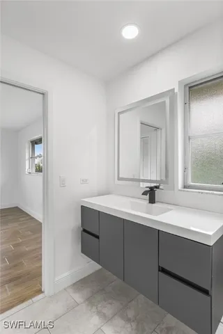 a bathroom with a sink and a mirror