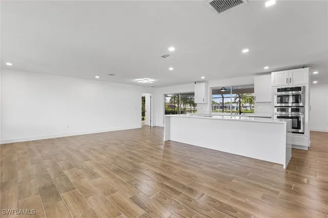 a view of kitchen with kitchen island and stainless steel appliances