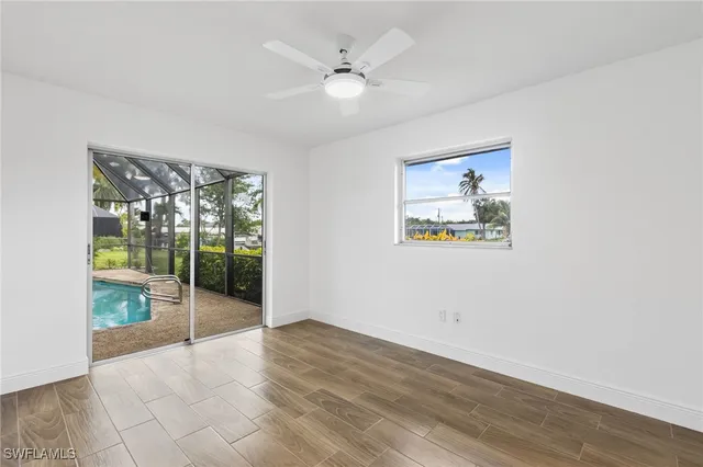wooden floor in an empty room with a window