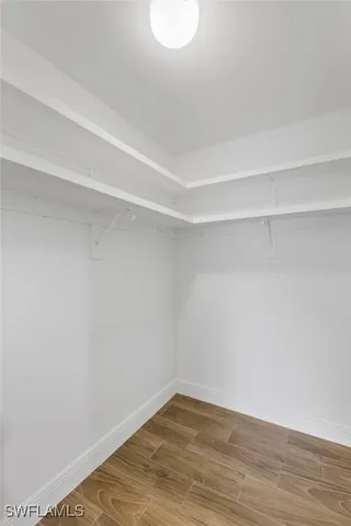 a view of a room with wooden floor