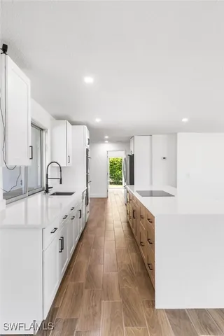 a large white kitchen with white cabinets