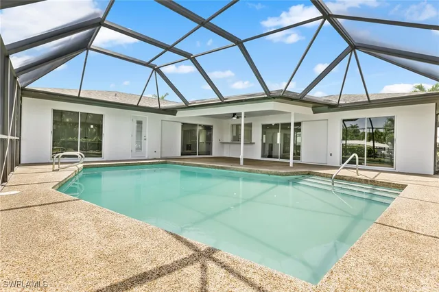 a view of a house with a backyard and a house