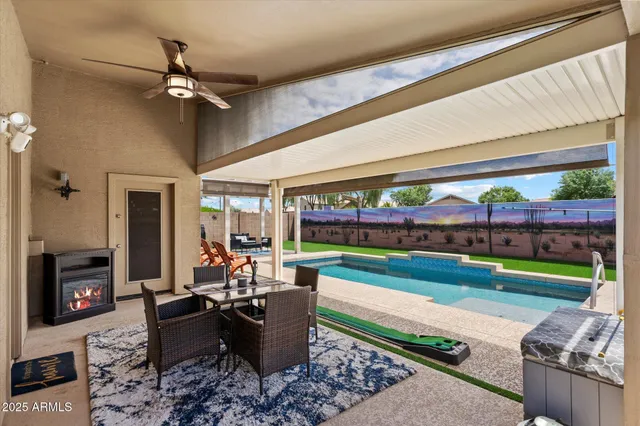 a living room with patio furniture and a fireplace
