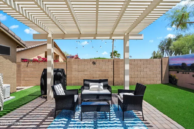 a view of a patio with couches table and chairs and potted plants