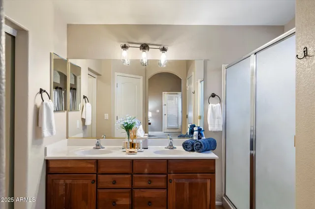 a bathroom with a double vanity sink and a mirror