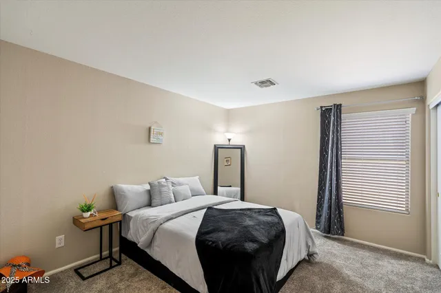 a bedroom with a bed and a window