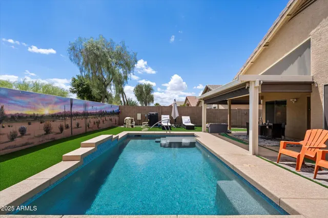 a swimming pool with outdoor seating and yard
