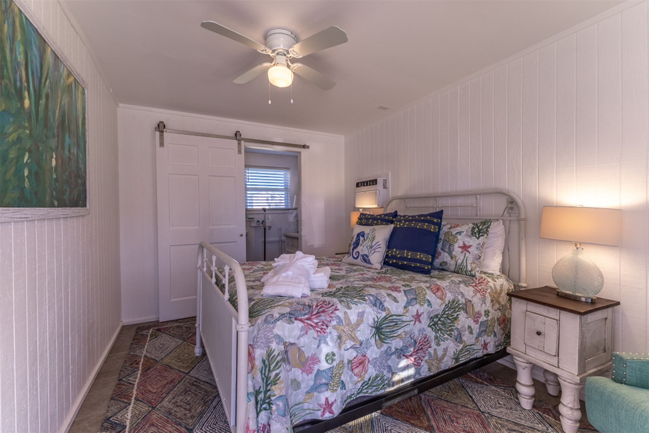 16618 Jean Lafitte Road Jamaica Beach, TX 77554 - Photo 24 of 47 a bedroom with a bed and a chandelier