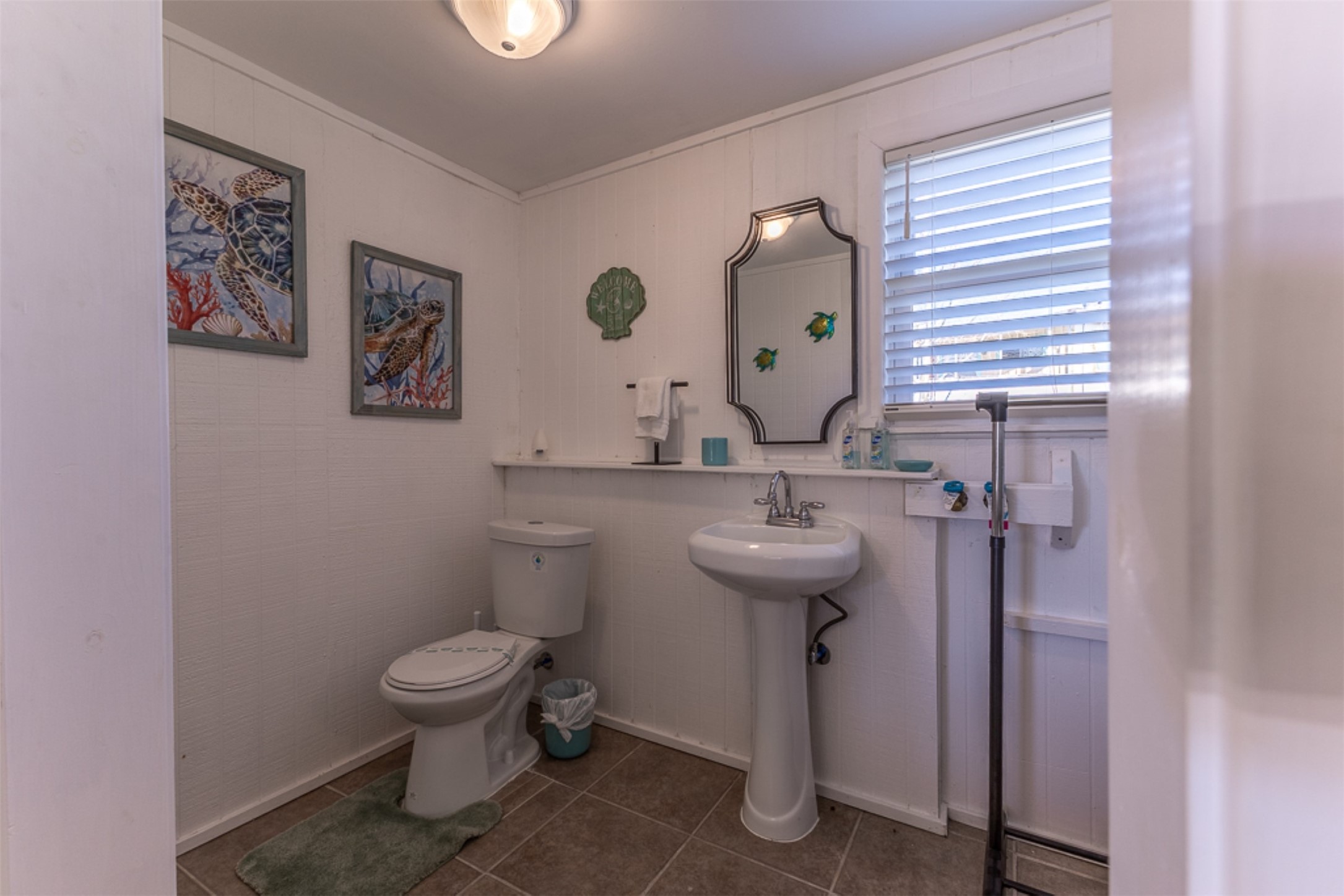 16618 Jean Lafitte Road Jamaica Beach, TX 77554 - Photo 26 of 47 a bathroom with a toilet sink and mirror