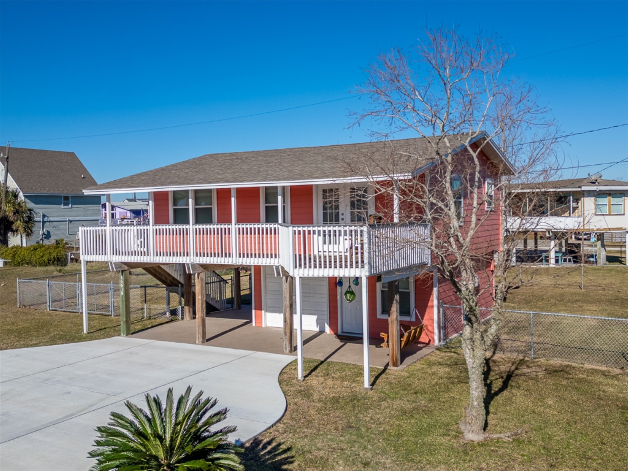 16618 Jean Lafitte Road Jamaica Beach, TX 77554 - Photo 4 of 47 a view of a house with wooden deck and furniture