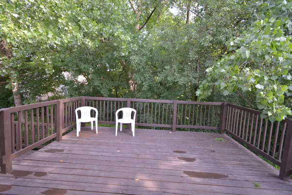 a view of balcony with wooden floor and outdoor seating