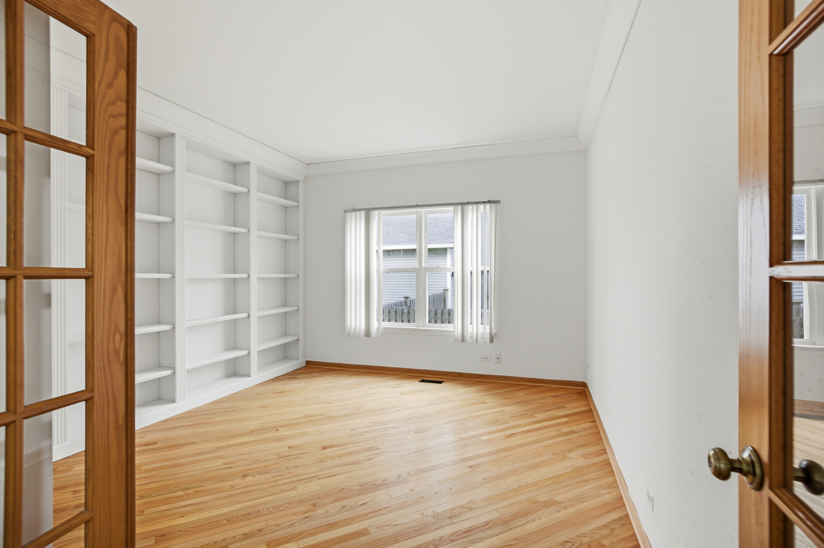 2812 Stuart Kaplan Court Aurora, IL 60503 - Photo 12 of 34 a view of an empty room with wooden floor and a window
