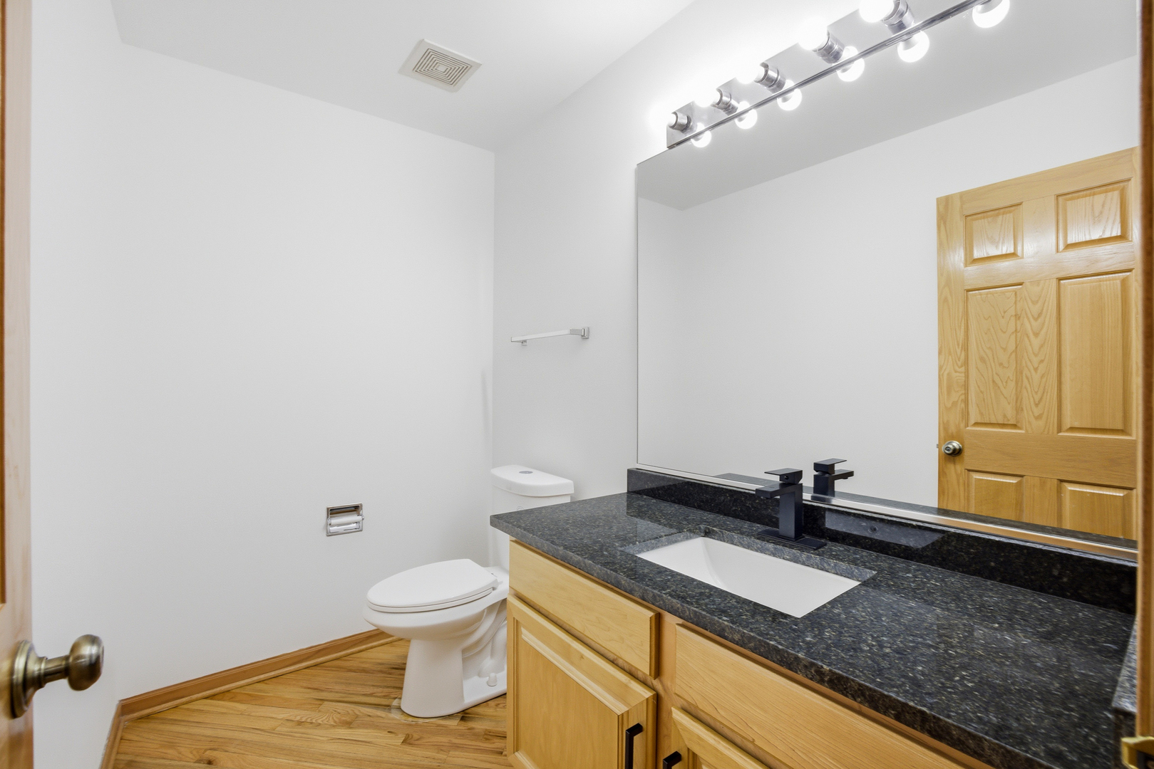 2812 Stuart Kaplan Court Aurora, IL 60503 - Photo 19 of 34 a bathroom with a granite countertop sink and a toilet
