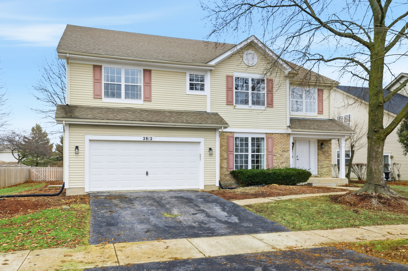 2812 Stuart Kaplan Court Aurora, IL 60503 - Photo 2 of 34 a front view of a house with a yard and garage