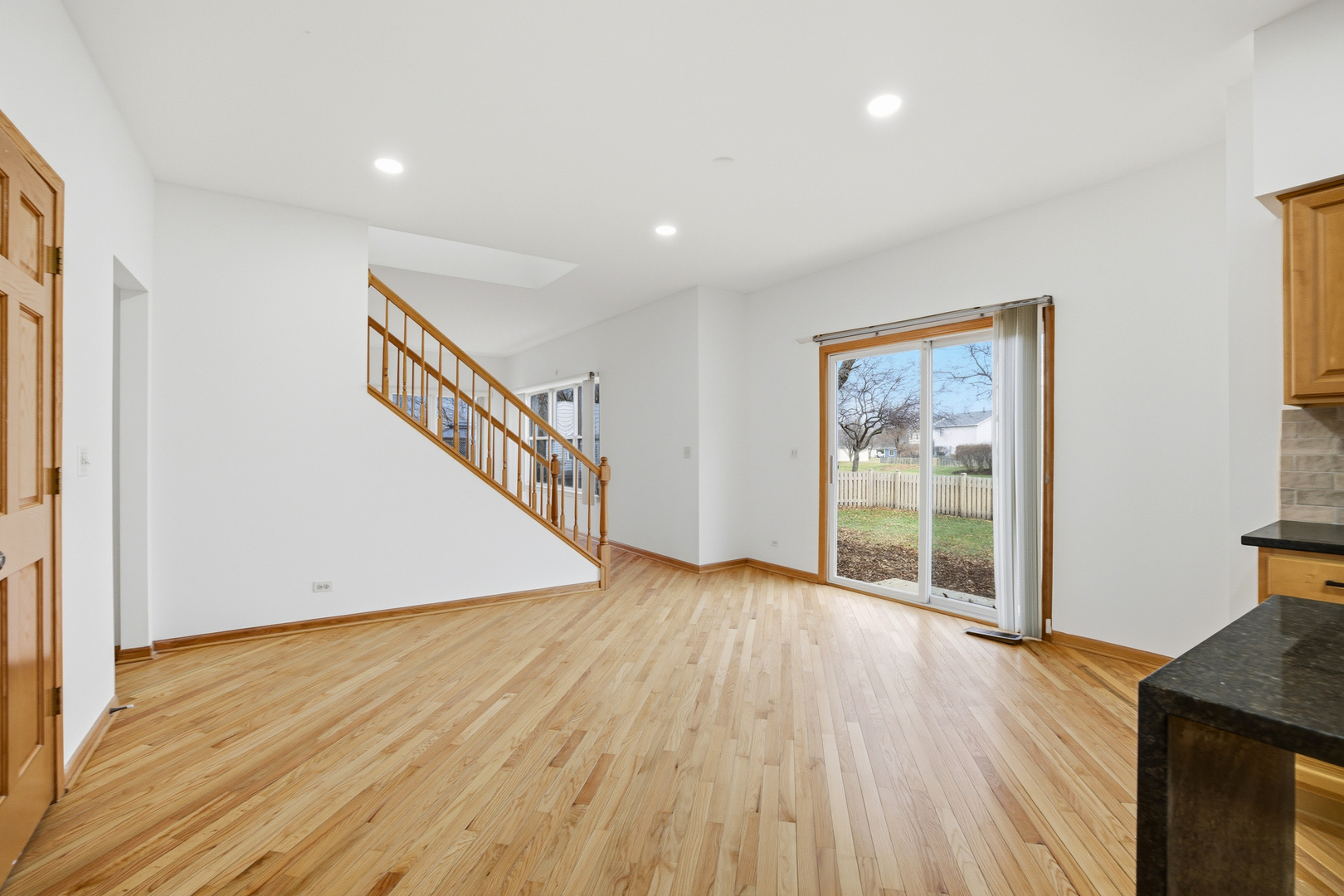 2812 Stuart Kaplan Court Aurora, IL 60503 - Photo 3 of 34 a view of an empty room with wooden floor and a window
