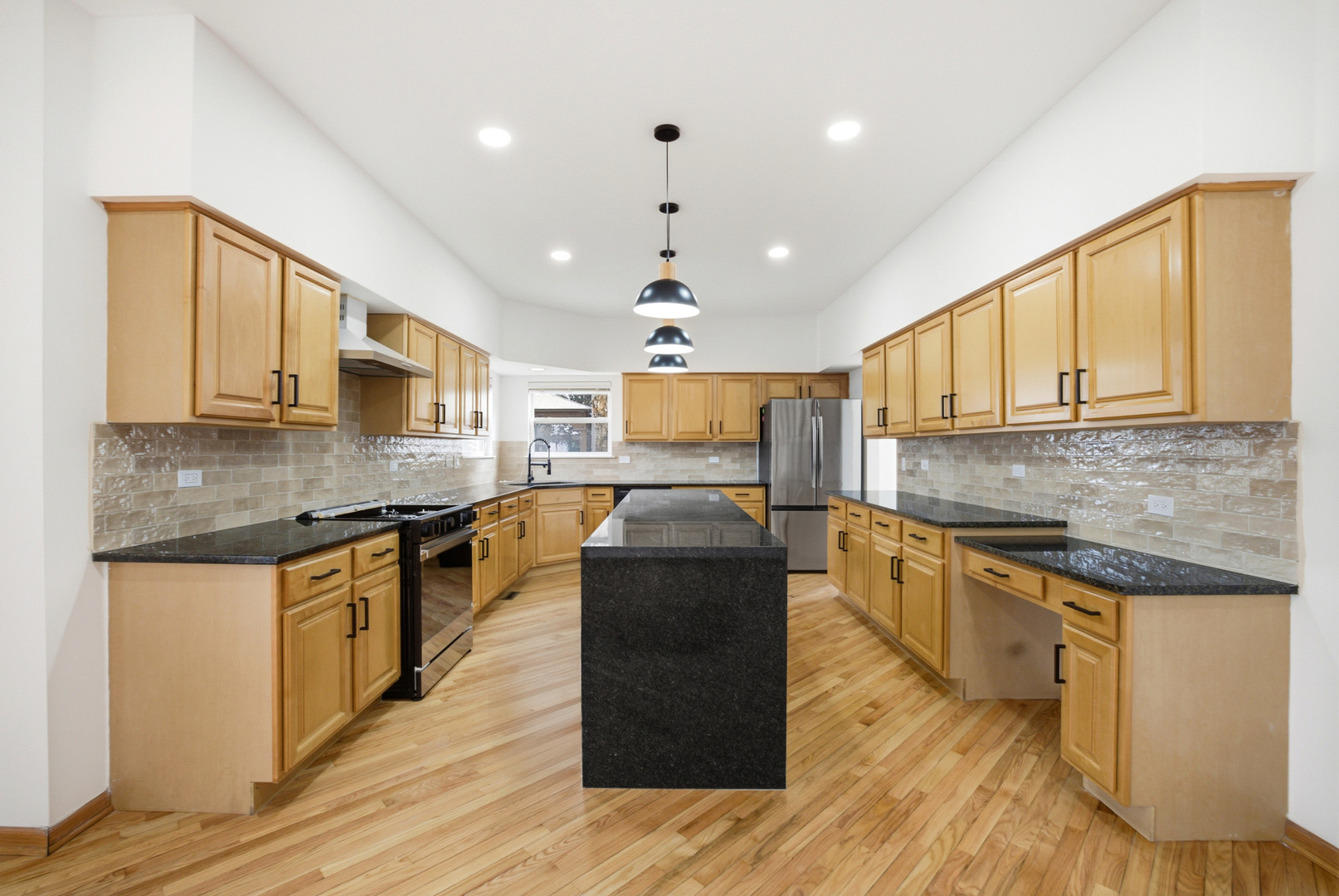 2812 Stuart Kaplan Court Aurora, IL 60503 - Photo 5 of 34 a kitchen with stainless steel appliances granite countertop wooden floors and white cabinets