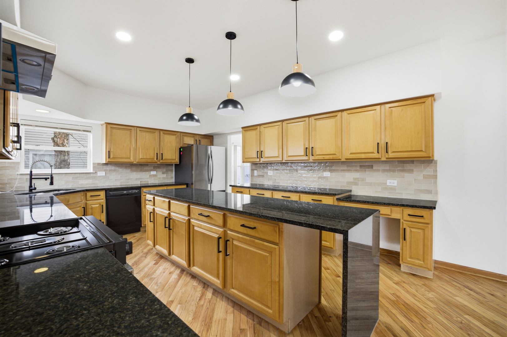 2812 Stuart Kaplan Court Aurora, IL 60503 - Photo 6 of 34 a kitchen with stainless steel appliances granite countertop a stove a sink and a microwave