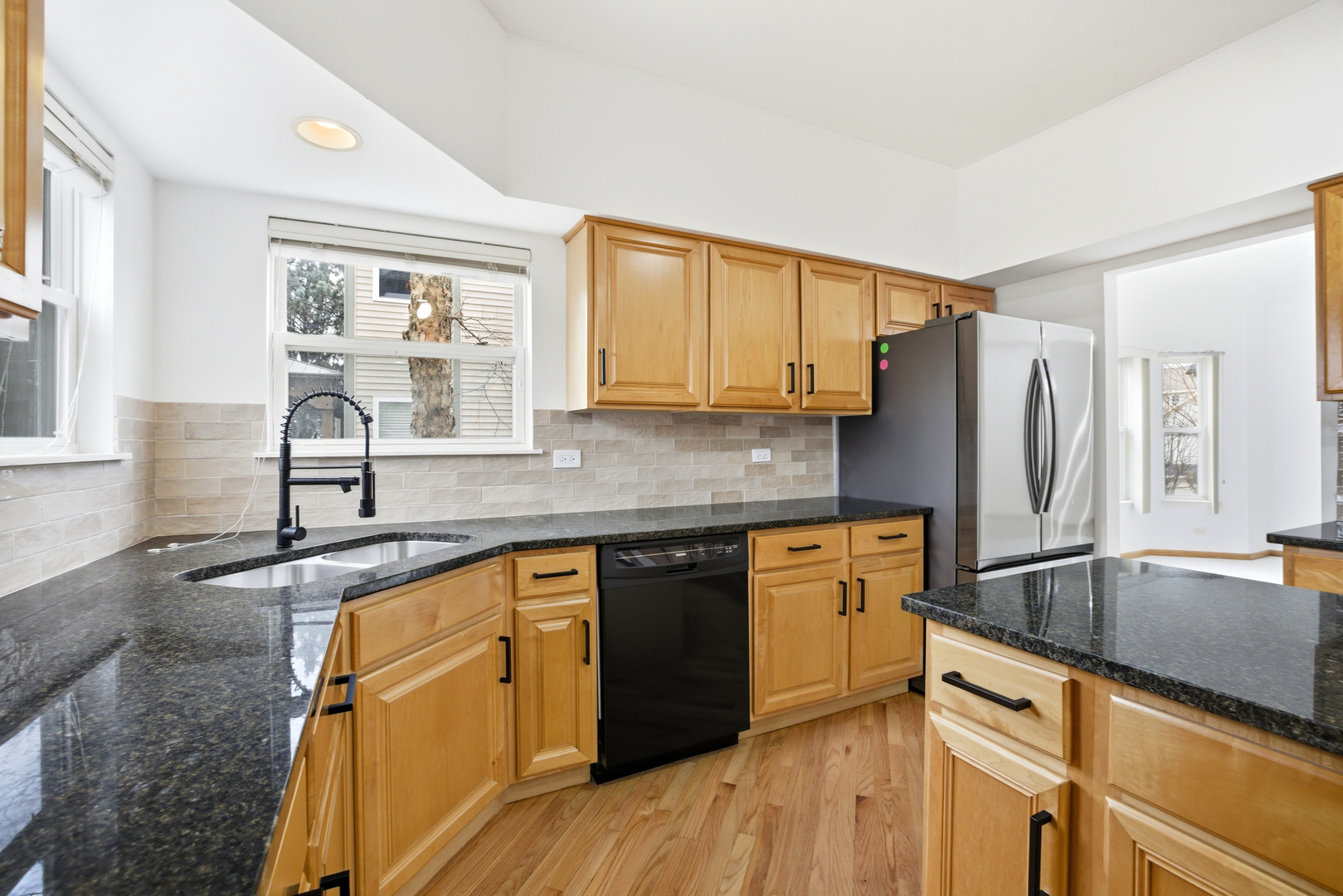 2812 Stuart Kaplan Court Aurora, IL 60503 - Photo 7 of 34 a kitchen with stainless steel appliances granite countertop a sink stove and refrigerator