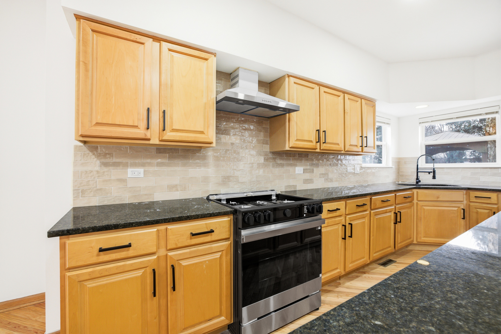2812 Stuart Kaplan Court Aurora, IL 60503 - Photo 8 of 34 a kitchen with granite countertop cabinets stainless steel appliances and a sink