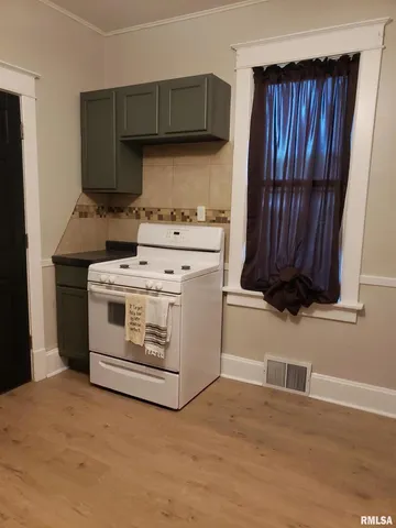 a kitchen with a stove and a cabinet