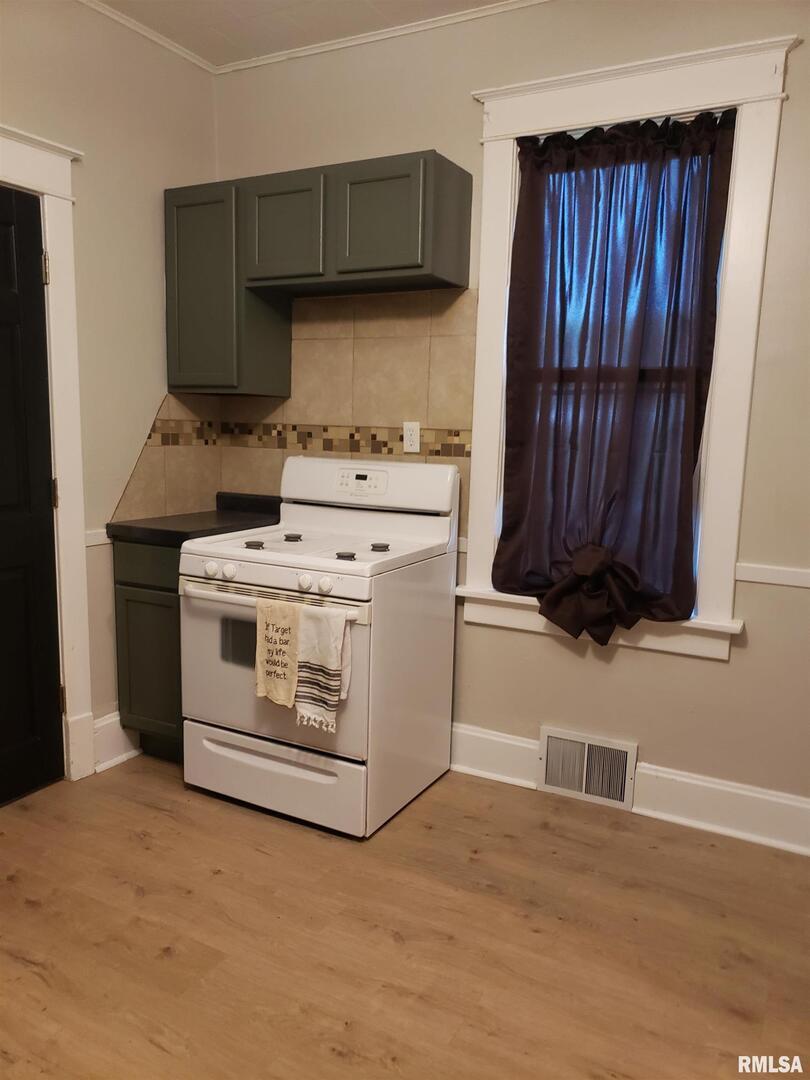 212 44th Street Moline, IL 61265 - Photo 8 of 23 a kitchen with a stove and a cabinet