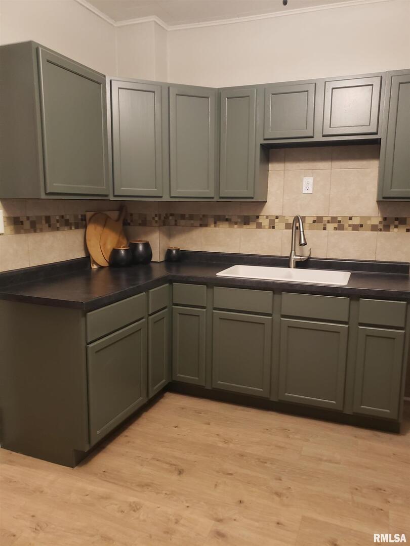 212 44th Street Moline, IL 61265 - Photo 10 of 23 a kitchen with stainless steel appliances granite countertop a sink and cabinets